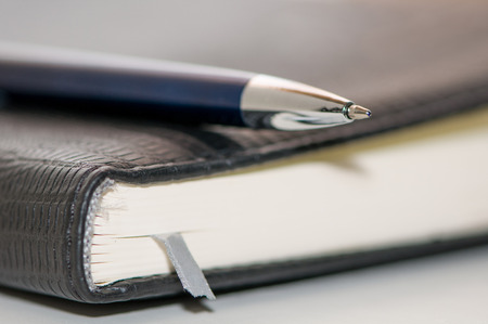 address book and ballpoint penの写真素材