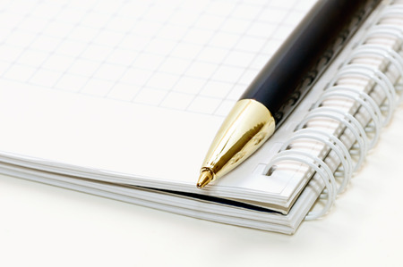 Notepad and pen on a white backgroundの写真素材