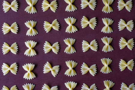 Dry pasta yellow on a dark background. Italian foodの写真素材