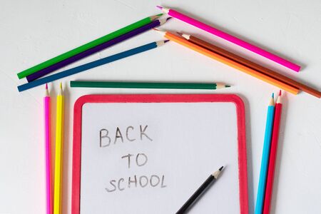 Many colored pencils lie on a white background. Copy spase. The concept of back to school, the educational process, study at school, drawing.の写真素材