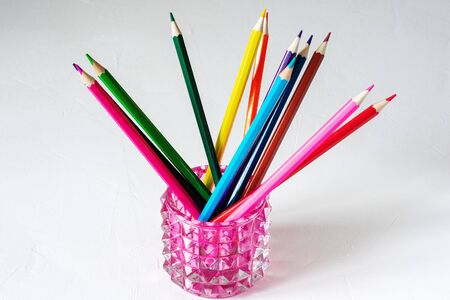 Many colored pencils lie on a white background. Copy spase. The concept of back to school, the educational process, study at school, drawing.の写真素材