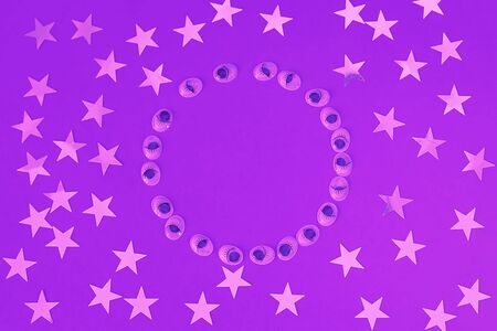 Decorative eyes on a lilac background. Helloween concept. Trick or treat. Creative concept for halloween. Flat lay, top view, copy space.の写真素材