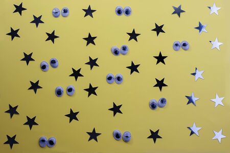 Decorative eyes on a yellow background background. Halloween concept Trick or treat. Creative concept for halloween. Flat lay, top view, copy space.の写真素材