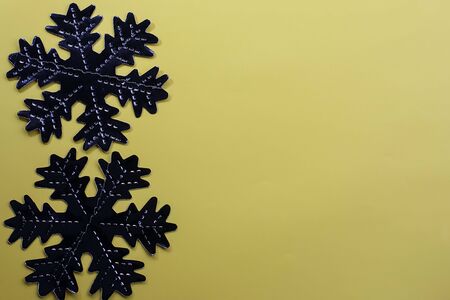 Snowflakes on a yellow background. Festive background. Holiday concept. Christmas and New Year concept. Top view, flat lay.の写真素材