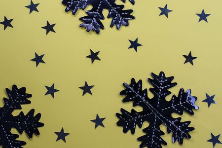 Snowflakes on a yellow background. Festive background. Holiday concept. Christmas and New Year concept. Top view, flat lay.の写真素材