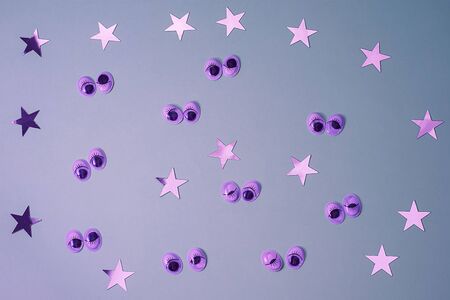 Decorative eyes on a gray background in neon light. Halloween trick or treat concept. Creative concept for halloween. Flat lay, top view, copy space.の写真素材