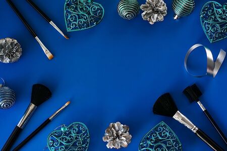 Christmas fashion flat lay. Cosmetic branding and Christmas tree toys.の写真素材