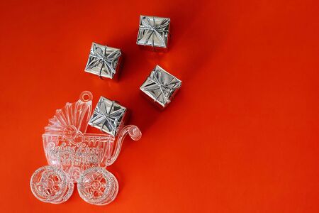 Baby carriage on a red