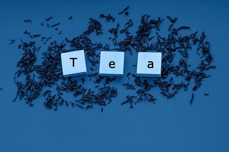 The inscription from the letters tea on a blue background. View from above. 2020 blue color...