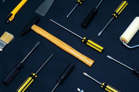 Flat lay with various hand construction tools on a black background. Labor day background concept