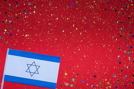 Independence Day of Israel. Flag of Israel on a festive red background. The concept of celebration, patriotism and celebration. Copy space. Flat lay.の写真素材