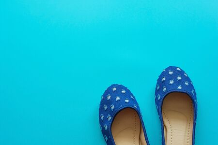 Vintage blue pair of polka dot shoes on a blue background.の写真素材