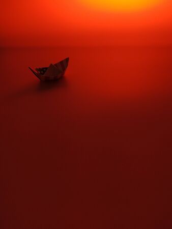 Paper boat on a red background. Columbus Day.の写真素材