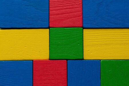 Colorful background of wooden toy blocks of red, yellow, green and blue colors.の写真素材