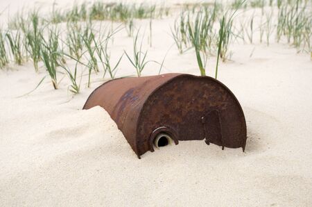 Rusty oil drum in the desertの写真素材
