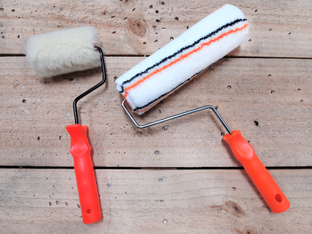 Paint roller on wooden backgroundの写真素材