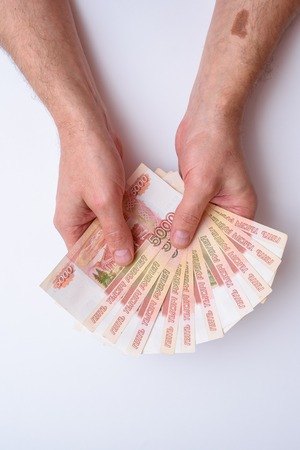 Five thousand russian rubles in hand isolated on white background. Bundle of banknotes of 5000...