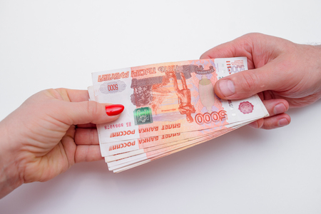 woman takes money from the man's handsの写真素材