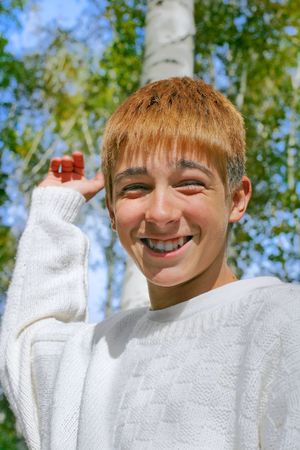 happy boy stand near the brich in autumn forestの写真素材