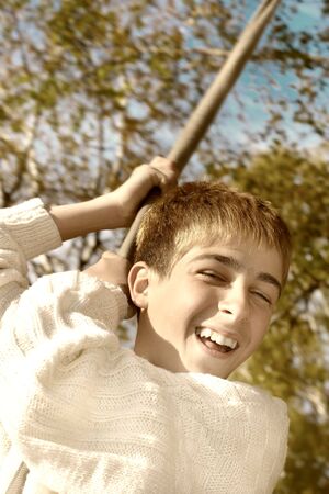 Young and happy teenager jumping on the bungee in the autumn forestの写真素材