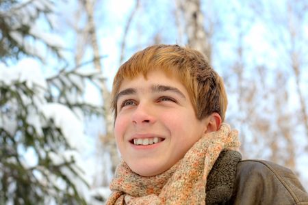 happy smiling teenager in winter forestの写真素材