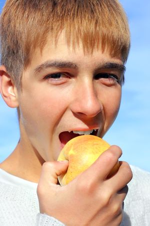 happy teenage boy with the appleの写真素材