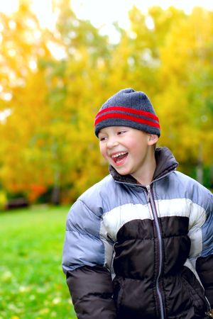 laughing kid stand in autumn parkの写真素材