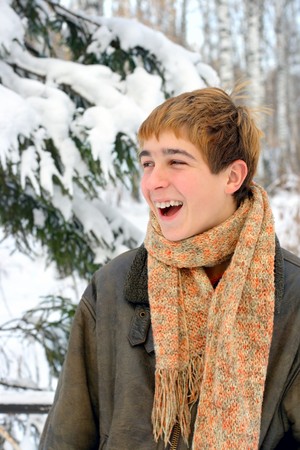 happy laughing teenager in winter forestの写真素材