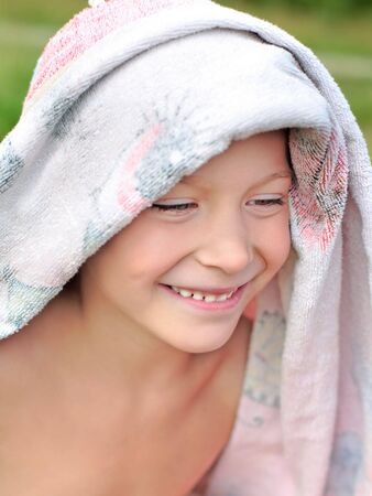 young boy on the beach after bathingの写真素材