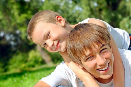 happy teenager and kid portrait outdoorの写真素材