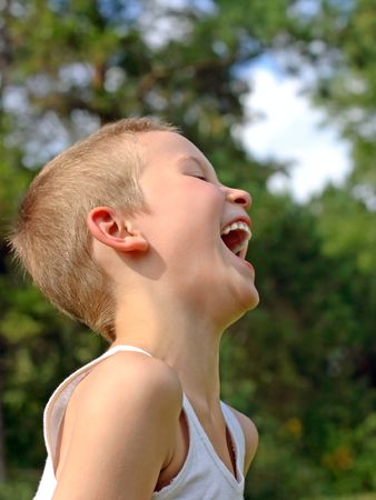 laughing kid stand in the parkの写真素材