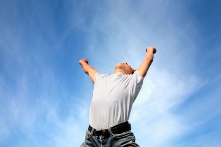 happy teenager jumping on blue sky backgroundの写真素材