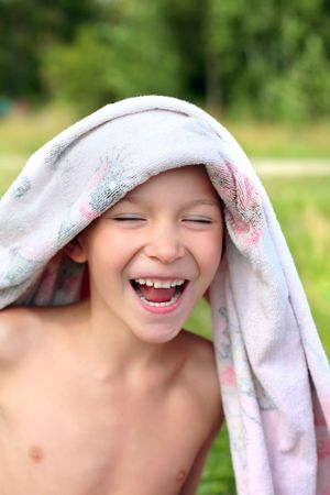 young boy on the beach after bathingの写真素材