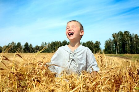 happy kid in wheat fieldの写真素材