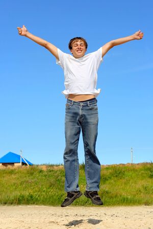 happy teenager jumping on the beachの写真素材