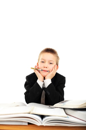 carefree schoolboy in classroom isolated over white backgroundの写真素材