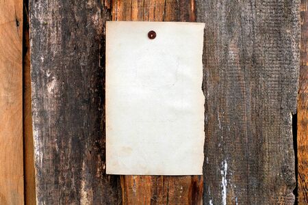 blank paper hanging on the wooden backgroundの写真素材