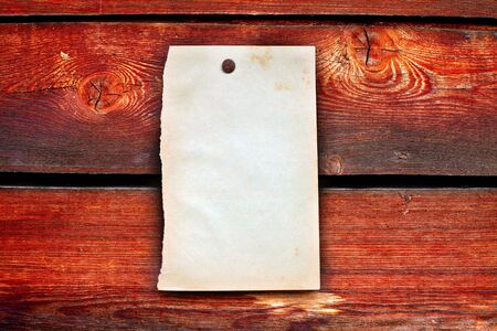 blank paper hanging on the wooden backgroundの写真素材