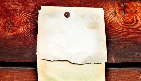 blank paper hanging on the wooden backgroundの写真素材