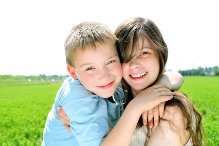brother and sister in the summer fieldの写真素材