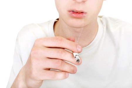 teenager with cigarette closeup  isolated on the white backgroundの写真素材