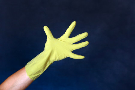 Hand in Rubber Glove on the dark backgroundの写真素材