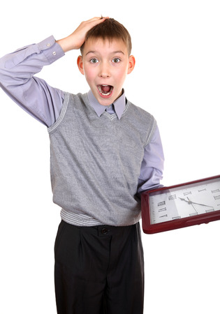 Surprised Boy with Big Clock Isolated on the White Backgroundの写真素材