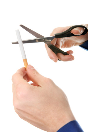 Person cutting a Cigarette with Scissors closeup Isolated on the White の写真素材