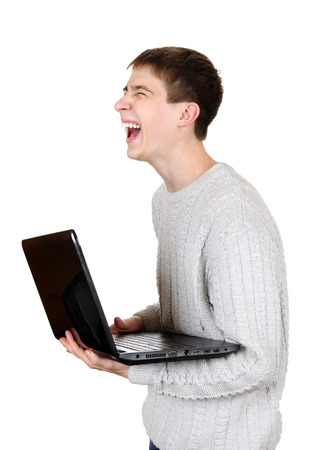 Happy Teenager Laughing with Laptop Isolated on the White Backgroundの写真素材