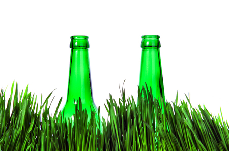 Two Green Bottles in the Grass Isolated on the White Backgroundの写真素材