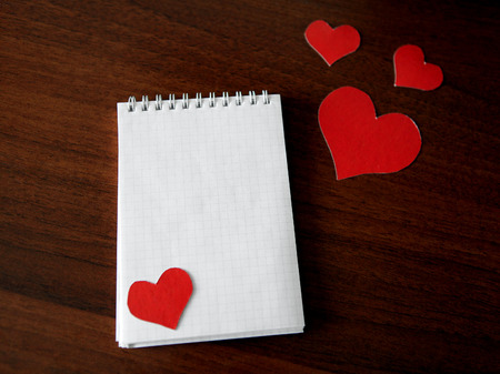 Blank Writing Pad with Heart Shapes on The Tableの写真素材