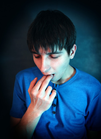Young Man feel Sick in the Dark Roomの写真素材