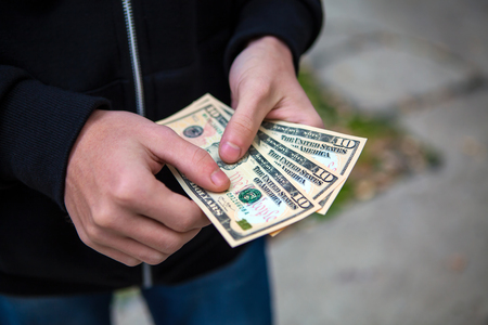 Person hold the Money on the Street closeupの写真素材