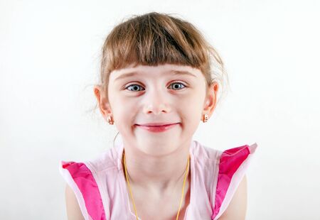 Cheerful Little Girl Portrait on the White Backgroundの写真素材
